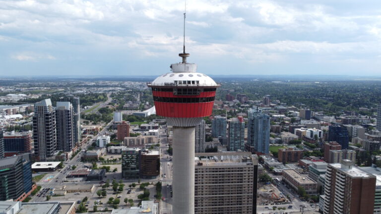 A panoramic aerial view of downtown Calgary featuring the Calgary Tower